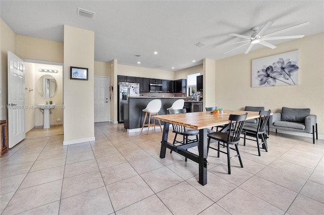 dining space with light tile patterned floors and ceiling fan