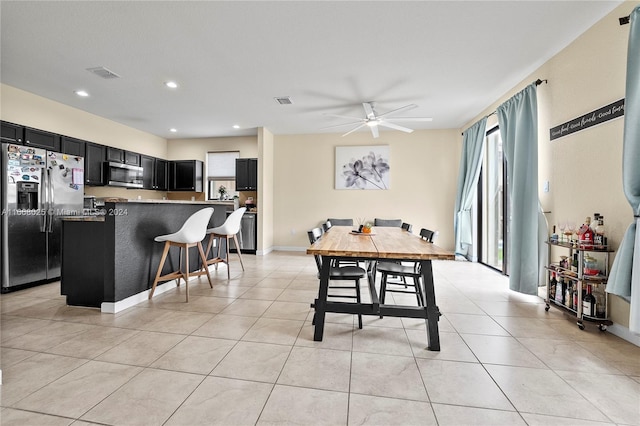 dining area with ceiling fan and light tile patterned floors