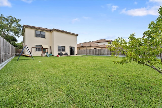 rear view of house featuring a lawn