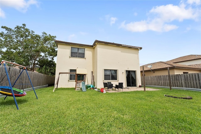 back of property featuring a patio area and a yard