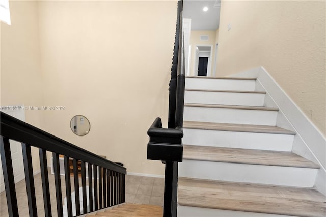 staircase with tile patterned flooring