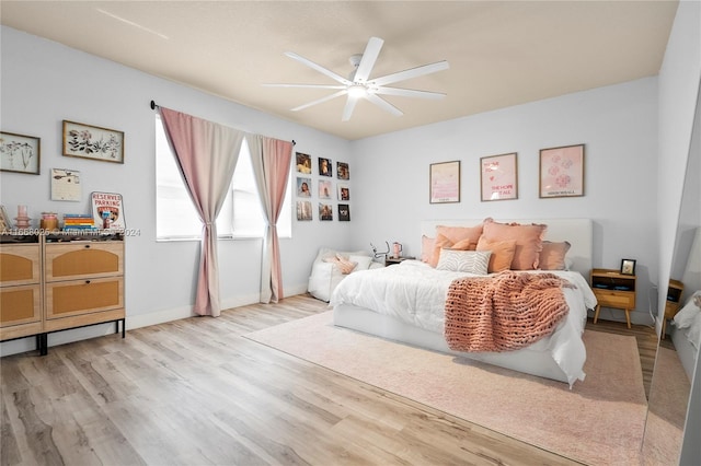 bedroom with light hardwood / wood-style floors and ceiling fan