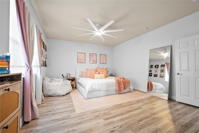 bedroom with ceiling fan and light hardwood / wood-style flooring