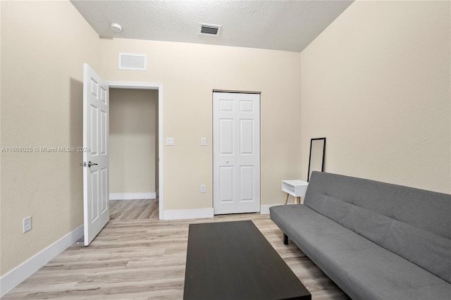 sitting room featuring a textured ceiling and light hardwood / wood-style flooring