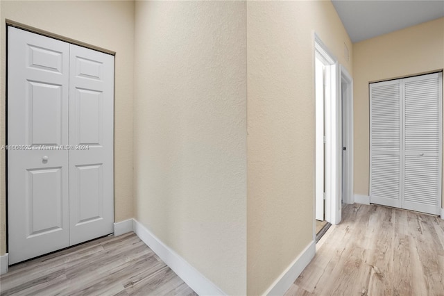 corridor featuring light wood-type flooring