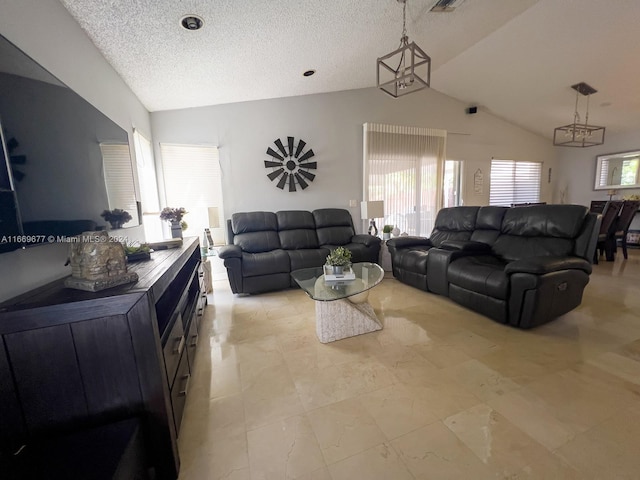 living room featuring a notable chandelier, a textured ceiling, and vaulted ceiling