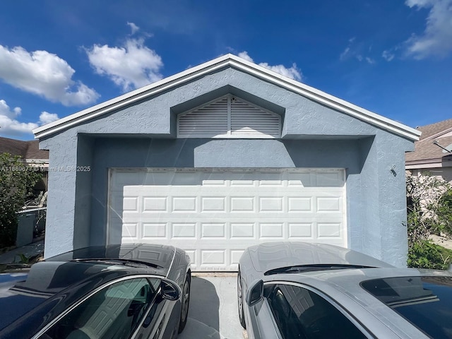 exterior space featuring stucco siding and a garage