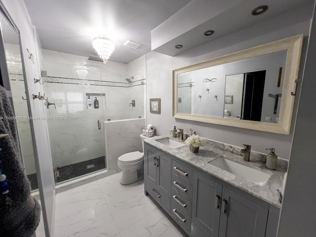 bathroom with a marble finish shower, marble finish floor, a sink, and toilet