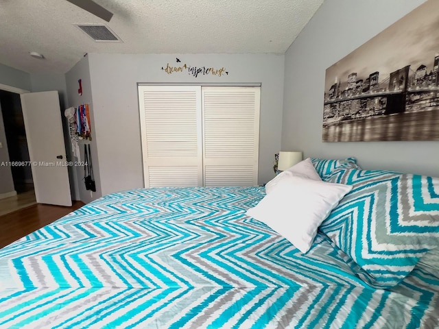 bedroom with a closet and a textured ceiling