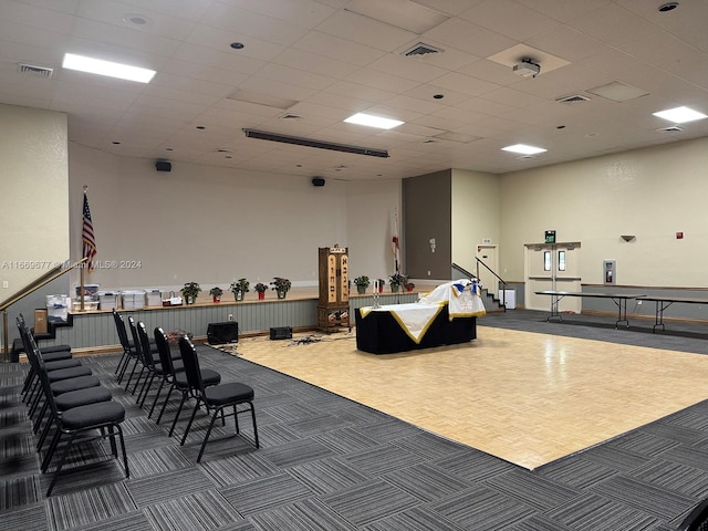 miscellaneous room with dark carpet and a drop ceiling