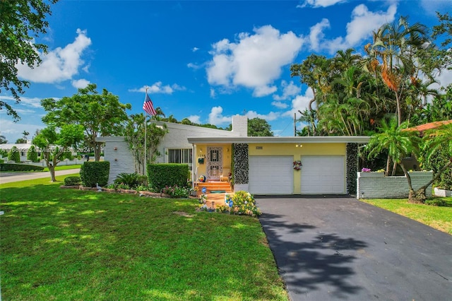 ranch-style house with a garage and a front lawn