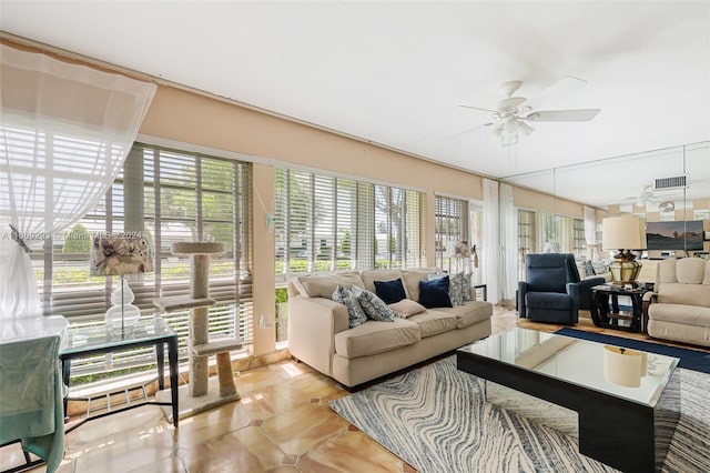 sunroom featuring ceiling fan