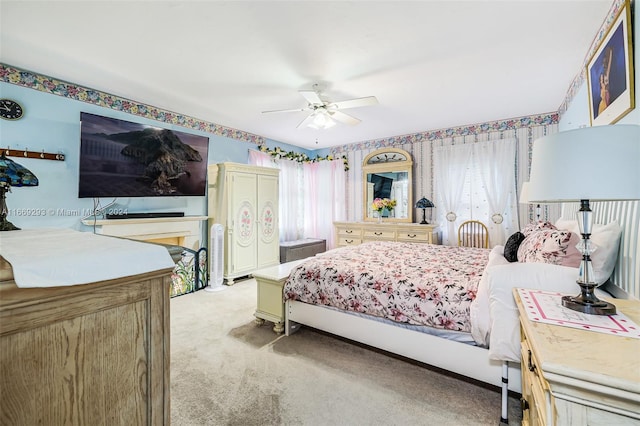 bedroom with light carpet, multiple windows, and ceiling fan