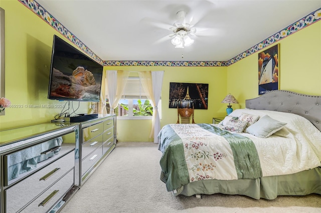 bedroom featuring ceiling fan and light carpet