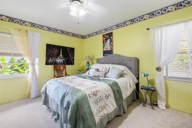 bedroom featuring ceiling fan and light carpet