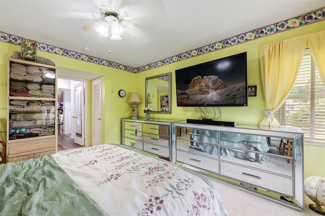 bedroom with a closet, ceiling fan, and carpet floors