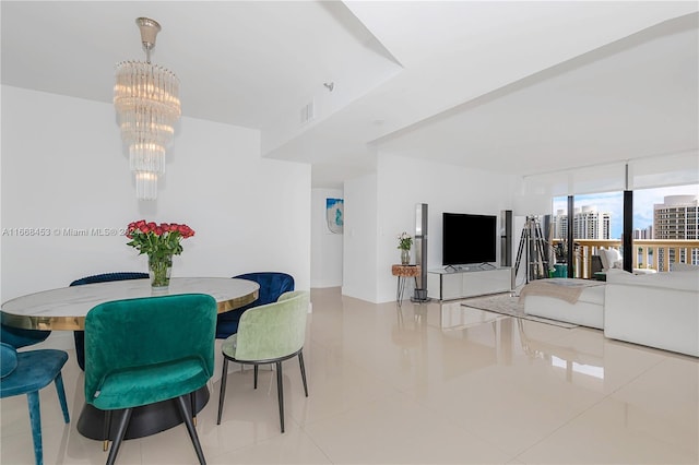 dining space featuring light tile patterned floors and a chandelier