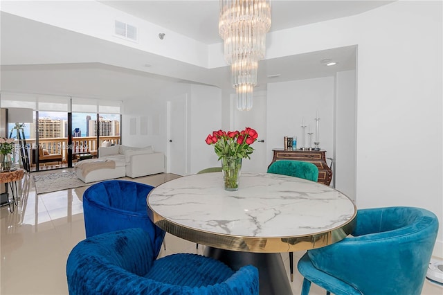 dining area with a chandelier and light tile patterned floors