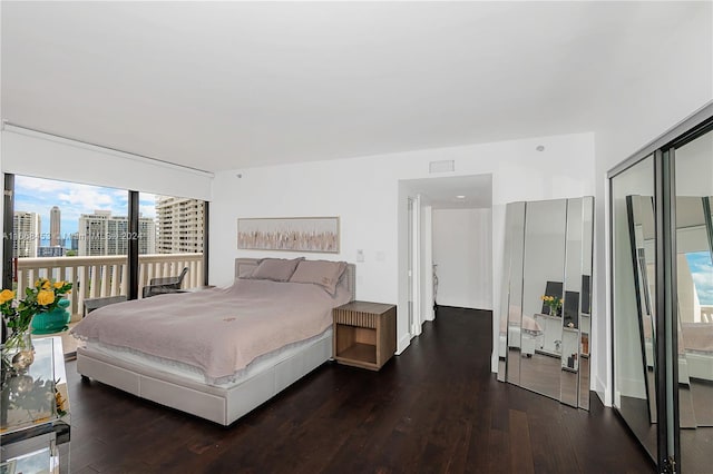 bedroom with dark hardwood / wood-style flooring