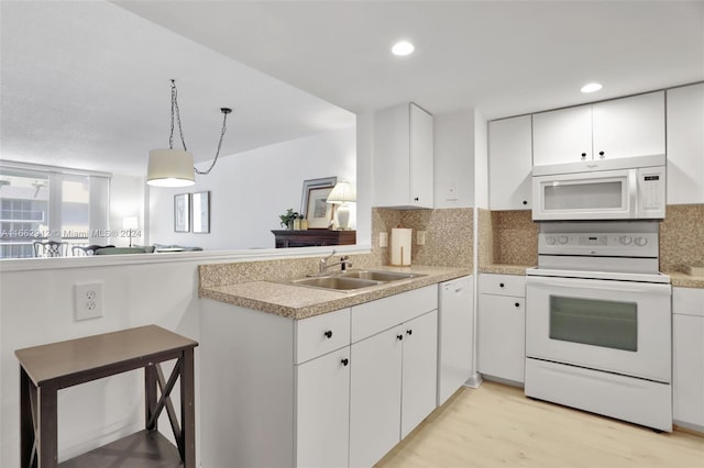 kitchen featuring light wood-type flooring, white appliances, white cabinetry, and sink