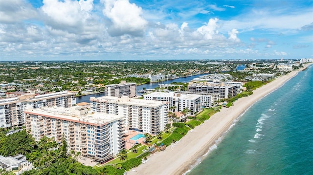 birds eye view of property featuring a water view and a beach view