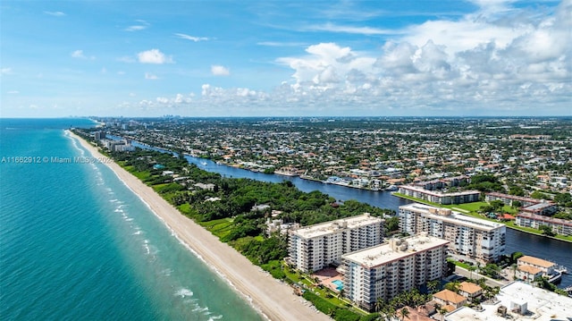 birds eye view of property with a water view and a view of the beach