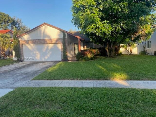 single story home featuring an attached garage, driveway, and a front lawn