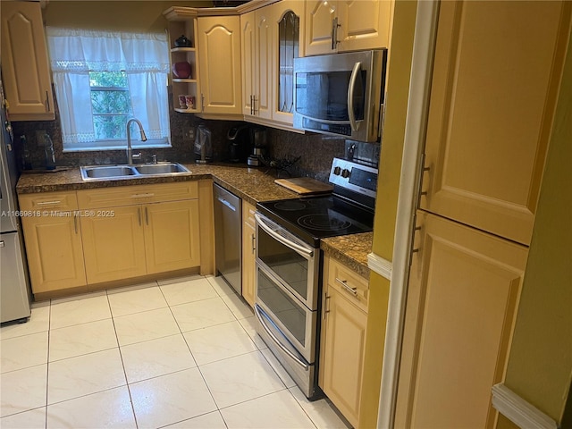 kitchen featuring decorative backsplash, dark countertops, stainless steel appliances, a sink, and light tile patterned flooring