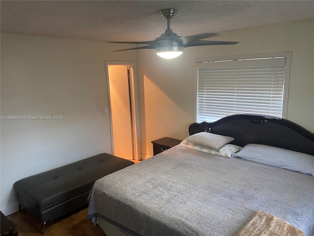 bedroom featuring a textured ceiling and a ceiling fan