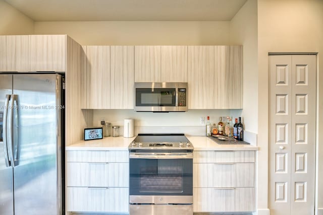 kitchen featuring light brown cabinetry and stainless steel appliances