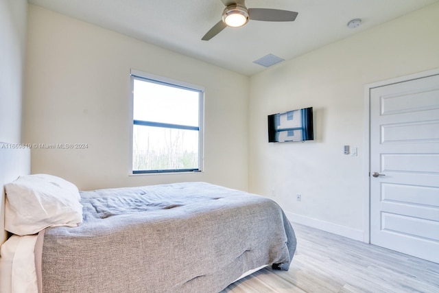 bedroom with light hardwood / wood-style floors and ceiling fan