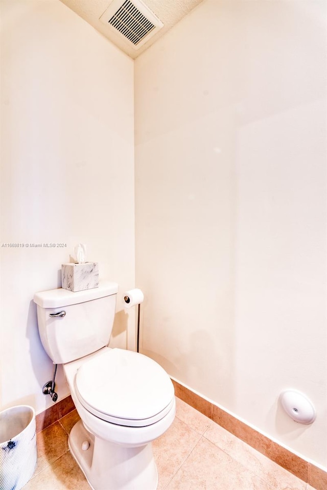 bathroom featuring tile patterned flooring and toilet