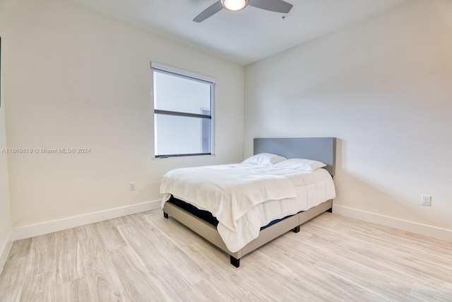 bedroom with light wood-type flooring and ceiling fan