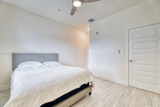 bedroom with light hardwood / wood-style floors and ceiling fan