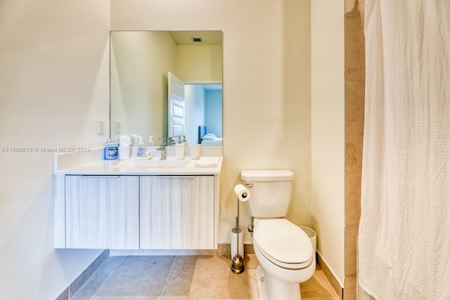 bathroom featuring walk in shower, vanity, toilet, and tile patterned floors