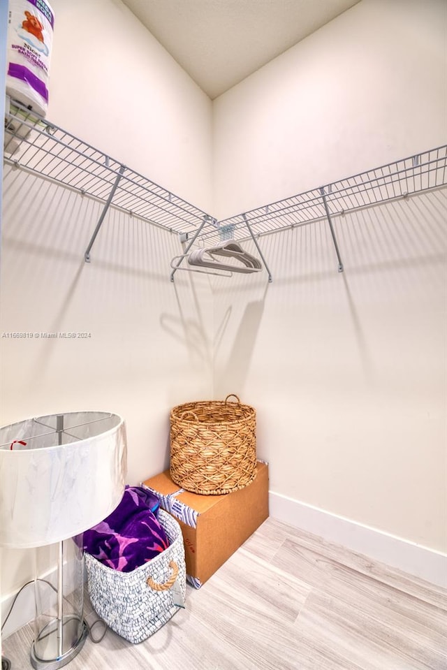 walk in closet featuring hardwood / wood-style flooring