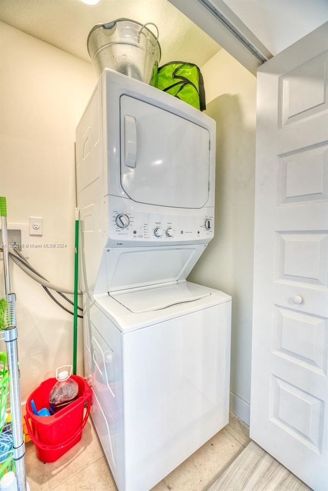 washroom featuring stacked washing maching and dryer