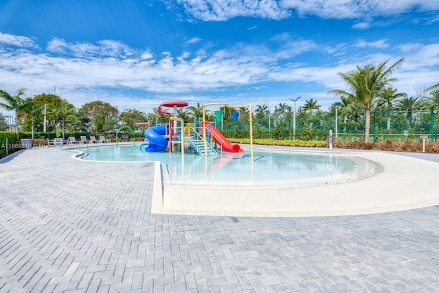 view of jungle gym featuring a community pool