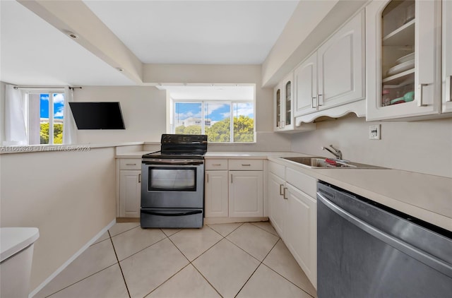 kitchen featuring dishwasher, black range with electric cooktop, white cabinetry, and a healthy amount of sunlight