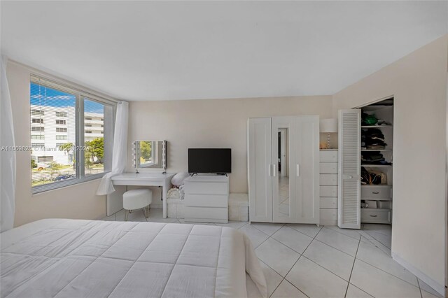 bedroom with light tile patterned floors