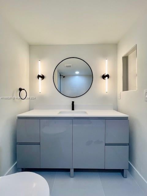 bathroom featuring tile patterned floors, vanity, and toilet