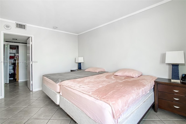 bedroom featuring ornamental molding and light tile patterned floors