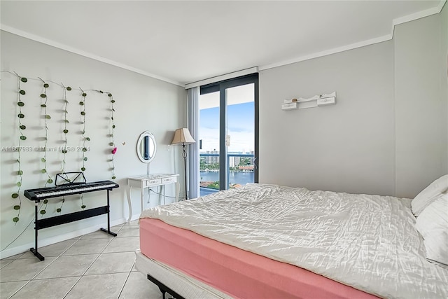 bedroom featuring crown molding, a water view, and light tile patterned floors