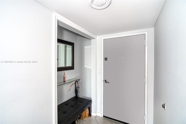 doorway with light tile patterned floors