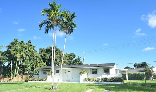 ranch-style home with a front lawn