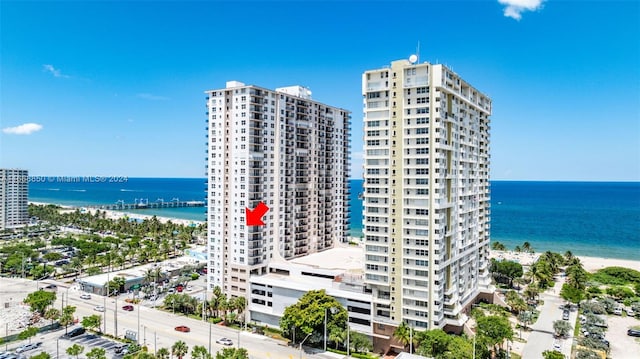 view of property with a beach view and a water view