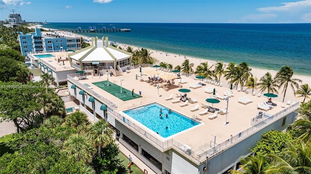 bird's eye view with a water view and a beach view