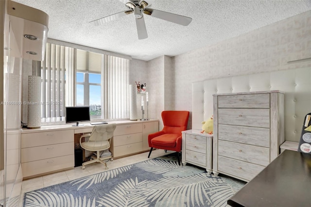 office space featuring ceiling fan, light tile patterned flooring, and a textured ceiling