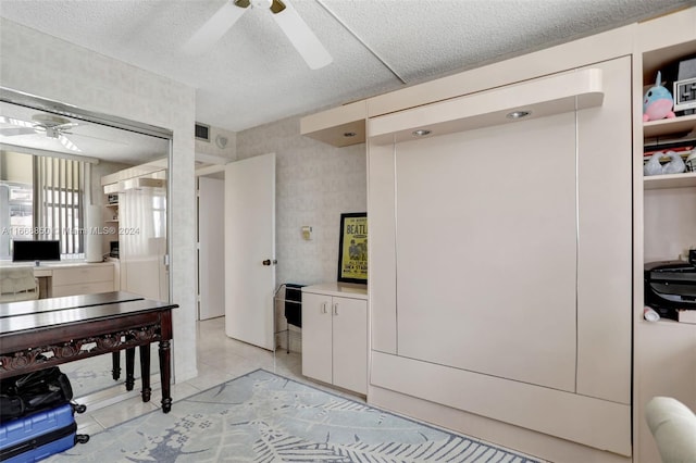 kitchen with ceiling fan and a textured ceiling