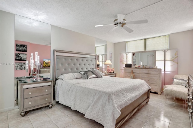 bedroom with ceiling fan, a textured ceiling, and light tile patterned floors